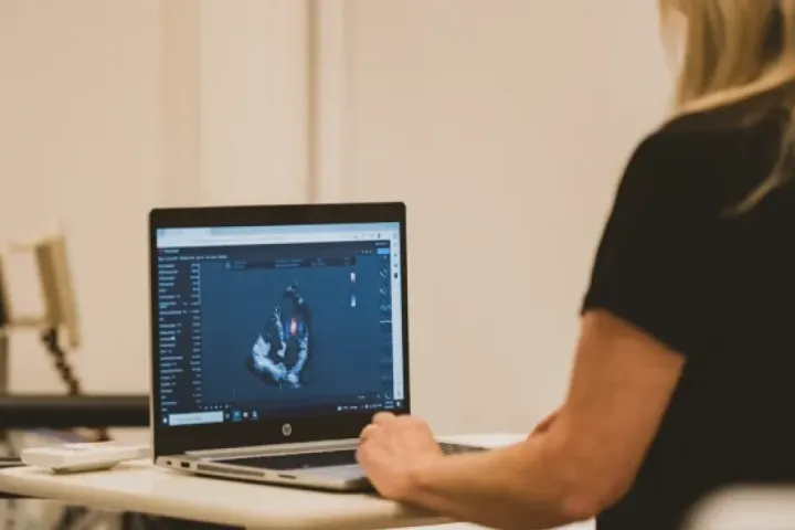 A clinician reviews an echocardiogram on a laptop at Victoria Heart